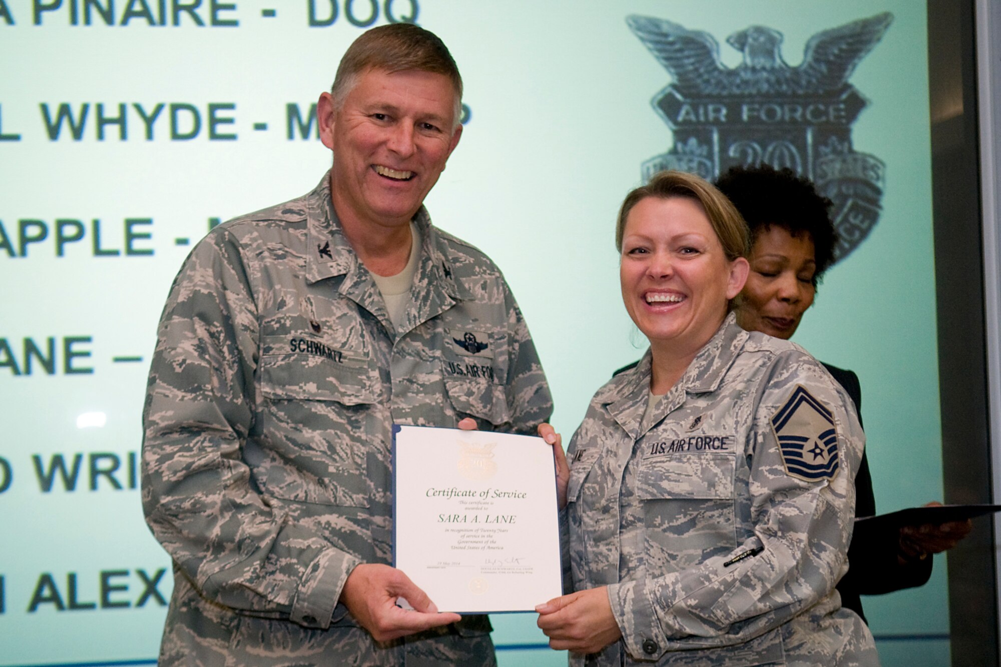Col. Doug Schwartz, 434th Air Refueling Wing commander, presents Senior Master Sgt. Sara Lane, 434th Aerospace Medicine Squadron , with a certificate of service for completing 20 years as a federal employee during a civilian commander's call at Grissom Air Reserve Base, Ind., Aug. 13, 2014. Civil service employees are an essential part Grissom and serve critical roles in maintaining unit readiness and daily operations. (U.S. Air Force photo/Tech. Sgt. Mark R. W. Orders-Woempner)
