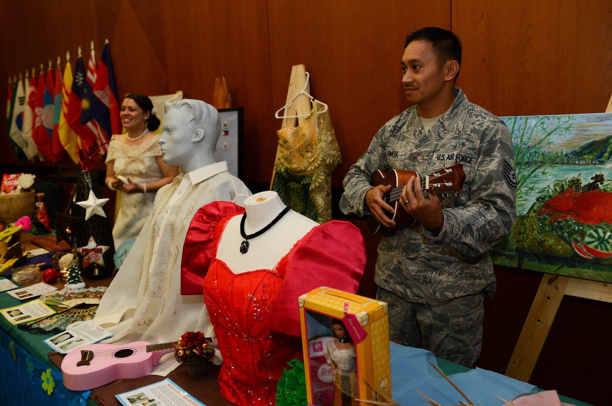 U.S. Air Force Tech. Sgt. Mark Romera, a 52nd Medical Support Squadron ultrasound technician from Daily City, Calif., plays a ukulele at a Filipino culture booth during a Diversity Day celebration at Spangdahlem Air Base, Germany, Aug. 21, 2014. Diversity Day promotes mutual respect and awareness for cultural diversity. More than 300 people attended the seventh annual Diversity Day celebration. (U.S. Air Force photo by Airman 1st Class Kyle Gese/Released)