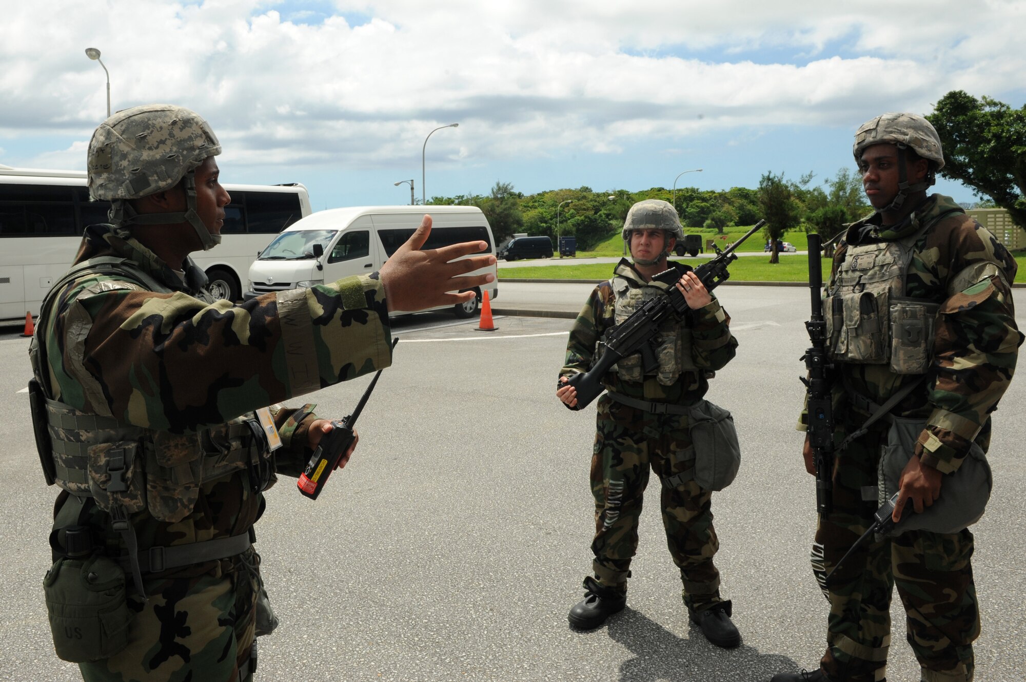 U.S. Air Force Staff Sgt. Kenneth Green, 18th Security Forces Squadron desk sergeant and Wing Inspection Team member, helps two airmen work through a vehicle-born explosive device scenario on Kadena Air Base, Japan, Aug. 21, 2014. Responsible for providing an accurate and unbiased report on their unit performance, WIT members are subject matter experts across the wing in their respective career fields. (U.S. Air Force photo by Airmen 1st Class Stephen G. Eigel)