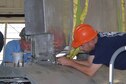 DAYTON, Ohio (08/2014) -- (From left to right) Restoration Specialists Roger Brigner, and Duane Jones attach the vertical stabilizer to the fuselage of the B-17F &quot;Memphis Belle&quot;&#174; at the museum&#39;s restoration hangar. Plans call for the aircraft to be placed on display in the museum&#39;s World War II Gallery in spring 2018. (U.S. Air Force photo)