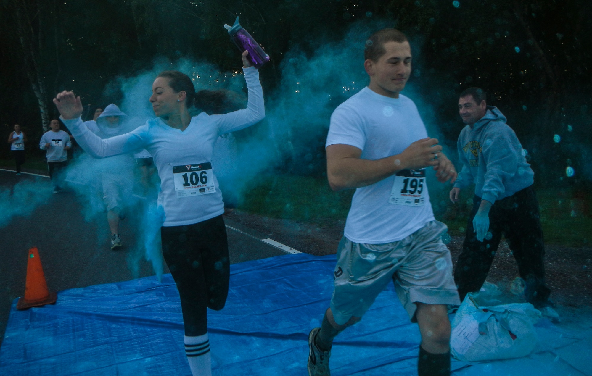 Participants are showered in color Aug. 21, 2014, during the Diversity Day 5K Color Run at Spangdahlem Air Base, Germany. More than 100 people participated in the color run to kick off Diversity Day. (U.S. Air Force photo by Staff Sgt. Christopher Ruano/Released)