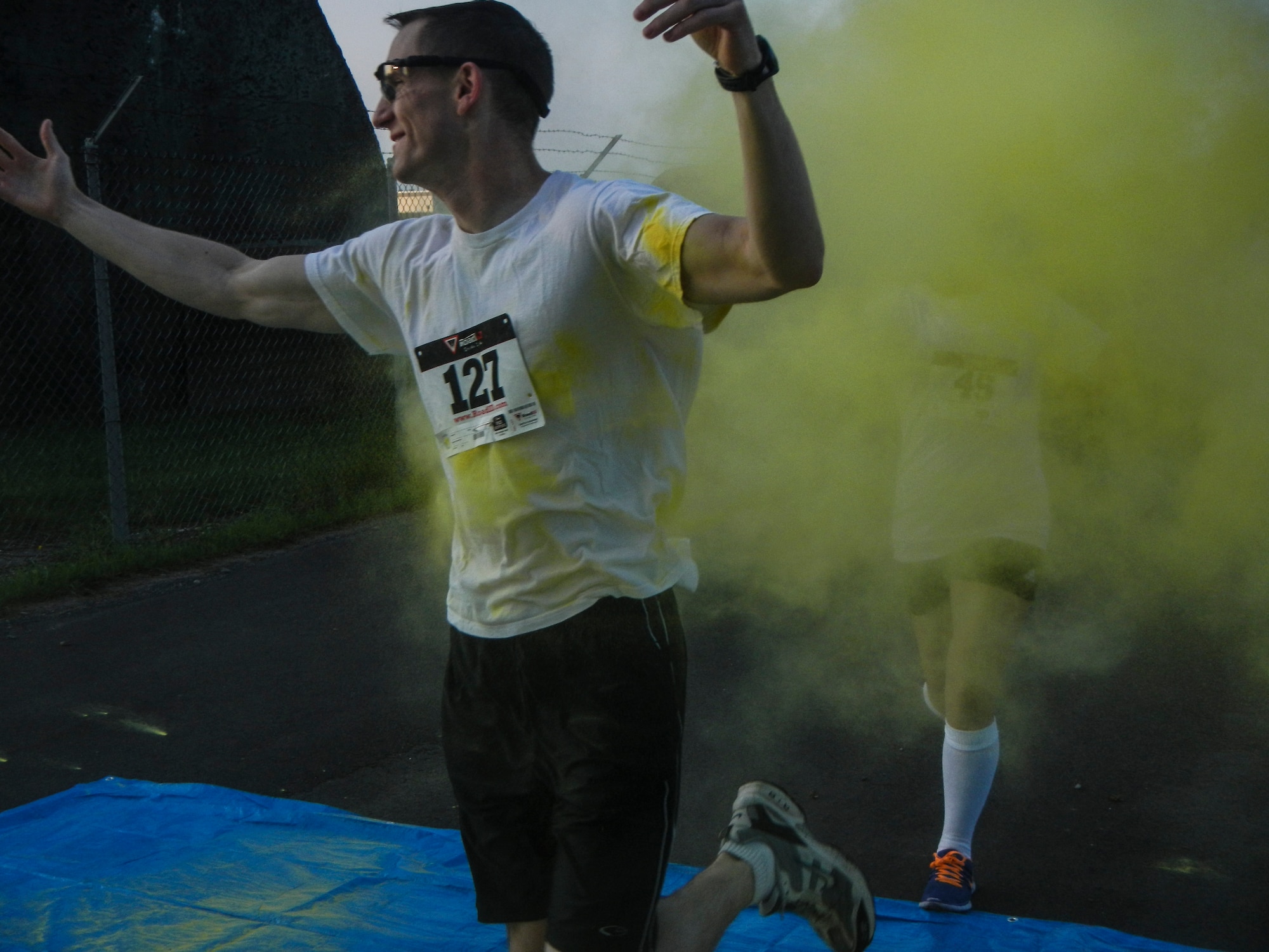 A color run participant is showered in color Aug. 21, 2014, during the Diversity Day 5K Color Run at Spangdahlem Air Base, Germany. Diversity Day held several events on base to highlight different cultures that are in the air force. (U.S. Air Force photo by Staff Sgt. Christopher Ruano/Released)