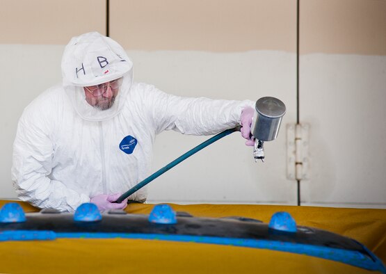 Henry Isaacs, 96th Logistics Readiness Squadron, prepares to paint the roof of a truck Aug. 20 at Eglin Air Force Base, Fla.  Repainting vehicle parts highly affected by the sun and weather is part of 96th LRS’s corrosion control program.  A three-person team is responsible for restoring and extending the lives of Eglin’s vehicle fleet.  Approximately 50 vehicles per year are painted by the team. (U.S. Air Force photo/Samuel King Jr.)