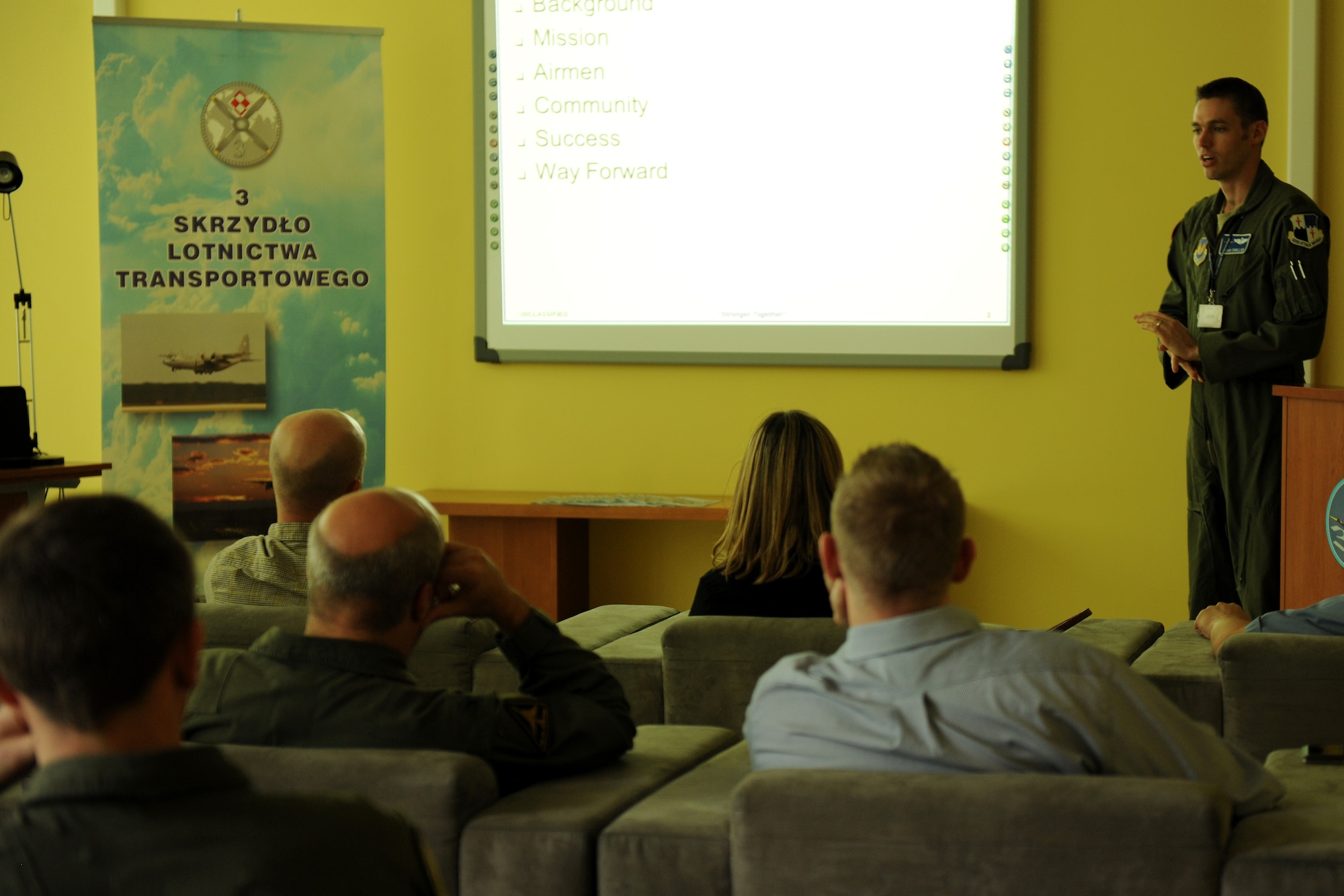 U.S. Air Force Maj. Micah Chollar, 52nd Operations Group Detachment 1 director of operations, briefs U.S. House Armed Services Committee professional staff members on the roles and responsibilities of the detachment, during a visit to Powidz Air Base, Poland, Aug. 20, 2014. The detachment, originally deployed from Spangdahlem Air Base, Germany, serves as a vital link between the Polish and U.S. militaries. (U.S. Air Force photo by Staff Sgt. Jarad A. Denton/Released)