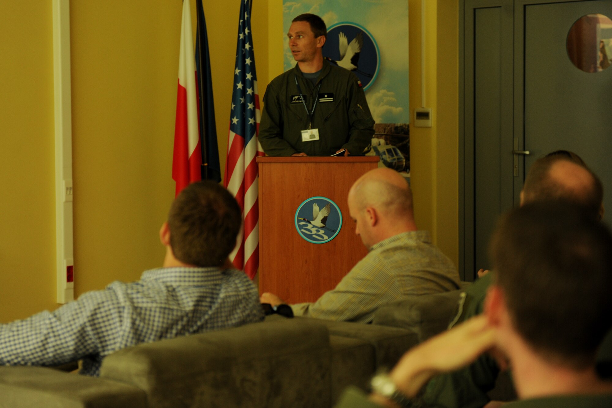Polish Army Maj. Miroslaw Jakubowski, 33rd Air Transport Base Operations Group deputy commander, briefs U.S. House Armed Services Committee professional staff members on the mission and capabilities of the installation, during a visit to Powidz Air Base, Poland, Aug. 20, 2014. As part of an ongoing commitment to strengthening NATO partnerships, Powidz has hosted U.S. Service members through multiple training exercises and operations. (U.S. Air Force photo by Staff Sgt. Jarad A. Denton/Released)