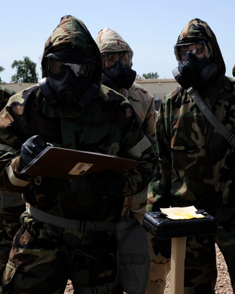 Airmen discover a G-Series nerve agent on M8 chemical agent detection paper during a chemical, biological, radiological, and nuclear defense survival skills class on Barksdale Air Force Base, La., Aug. 19, 2014. The Airmen were required to report their findings during the exercise so other units could respond properly to the simulated nerve agent. (U.S. Air Force photo/Senior Airman Joseph A. Pagán Jr.)