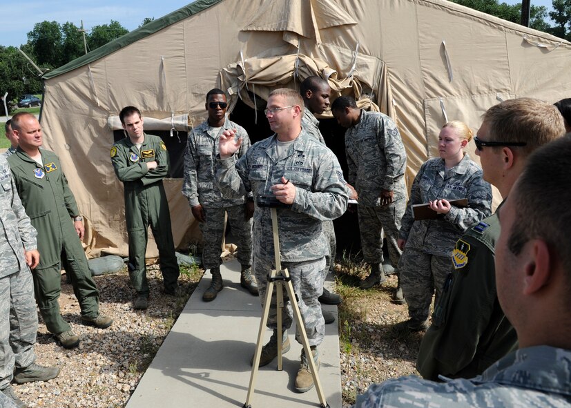 Tech. Sgt. Clinton McDaniel, 2nd Civil Engineer Squadron emergency management plans and logistics section chief, teaches Airmen how to set up a liquid detection stand during a chemical, biological, radiological, and nuclear defense survival skills class on Barksdale Air Force Base, La., Aug. 19, 2014. The stand is used to detect chemical agents. (U.S. Air Force photo/Senior Airman Joseph A. Pagán Jr.)