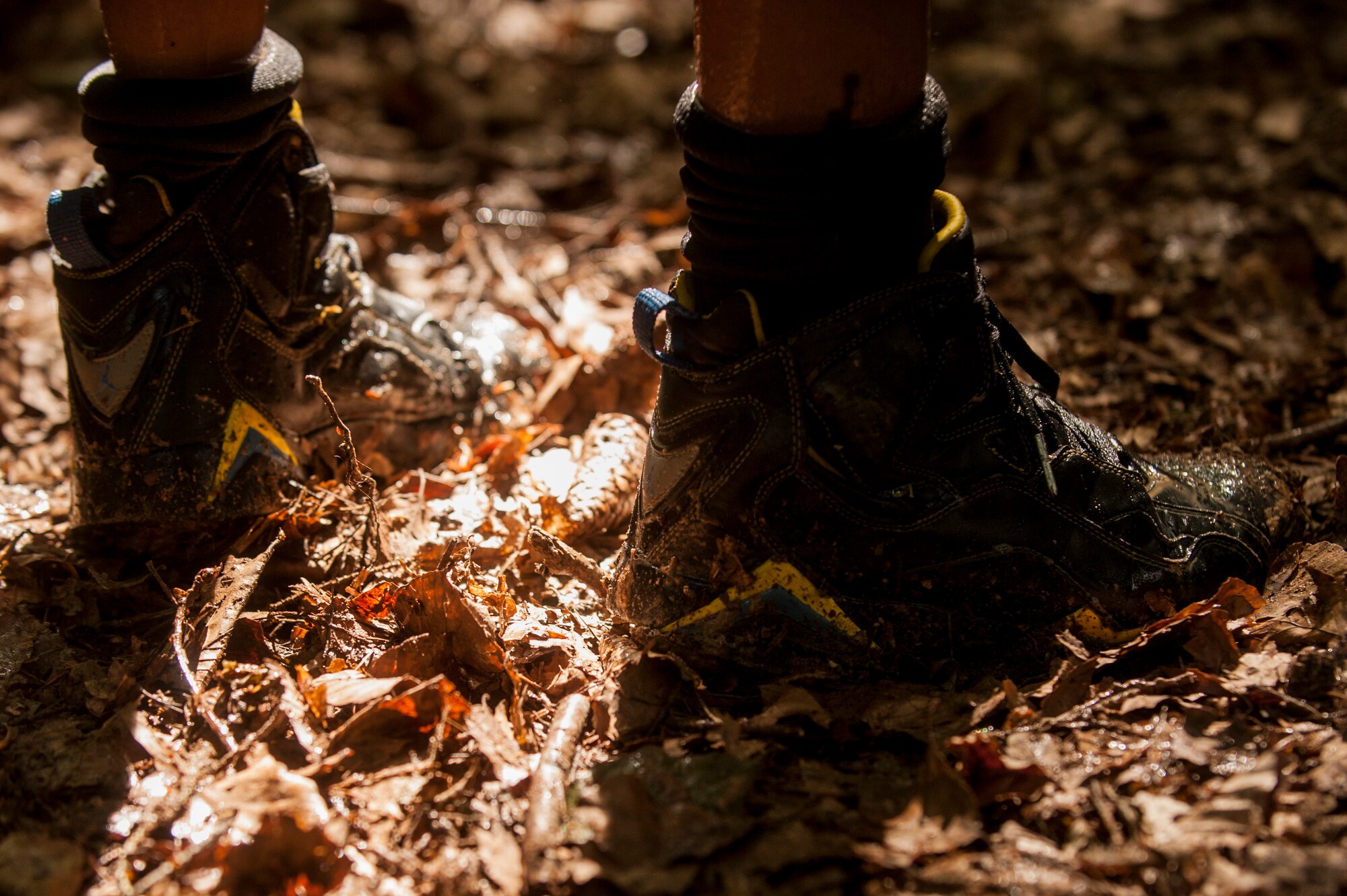A base Airman’s shoes are covered in mud during the second annual Tier II 5K Mud Run Aug. 20, 2014 at Spangdahlem Air Base, Germany. The event provided a way for 52nd Fighter Wing Airmen to enjoy some camaraderie while also getting down and dirty. (U.S. Air Force photo by Senior Airman Rusty Frank/Released)