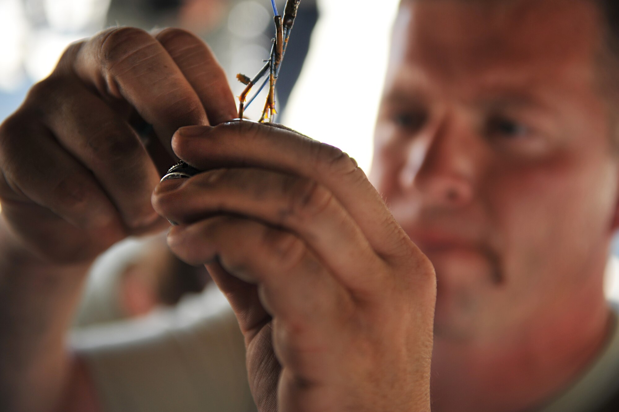 Tech. Sgt. Timothy Graham, 493rd Aircraft Maintenance unit avionics craftsman, repairs the wiring on an F-15C Eagle Aug. 19, 2014. As an avionics craftsman, it’s Graham’s job to repair aircraft to keep them mission ready. (U.S. Air Force photo/Senior Airman Hailey Haux)