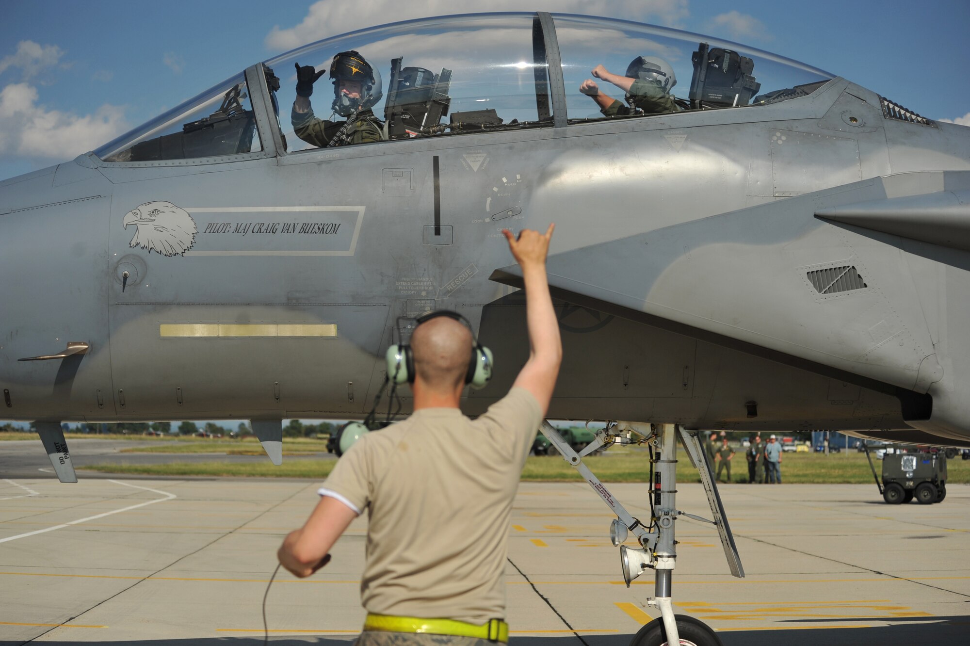 Tech. Sgt. Timothy Graham (right), 493rd Aircraft Maintenance Unit avionics craftsman, sits in the back of an F-15C Eagle as it taxies to the runway Aug. 18, 2014. Coming up on his retirement and last temporary duty to Plovdiv, Bulgaria where Airmen are conducting bilateral training, Graham was finally able to take that flight. (U.S. Air Force photo/Senior Airman Hailey Haux)
