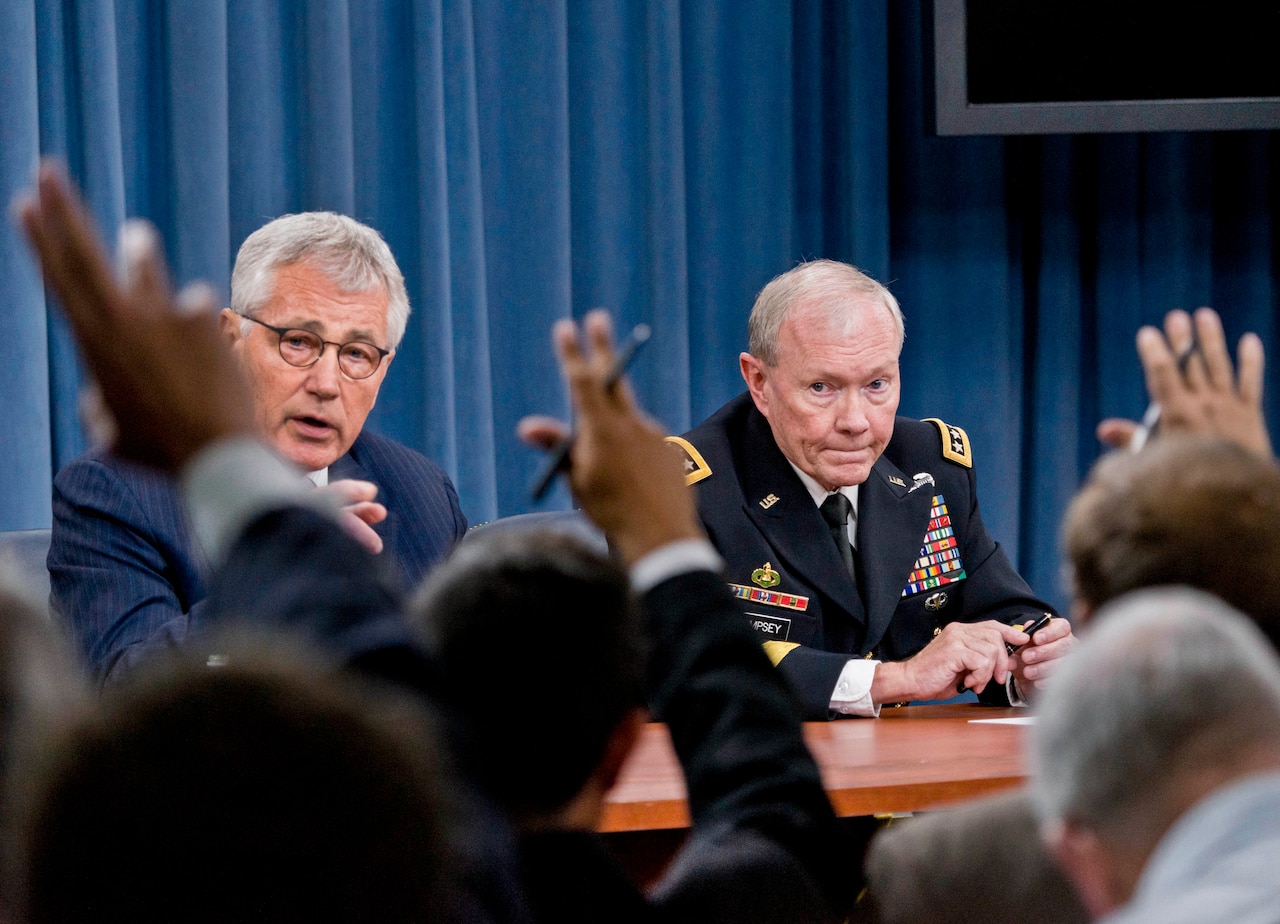 Defense Secretary Chuck Hagel and Army Gen. Martin E. Dempsey, chairman of the Joint Chiefs of Staff, brief reporters at the Pentagon, Aug. 21, 2014. DOD photo by U.S. Army Staff Sgt. Sean K. Harp