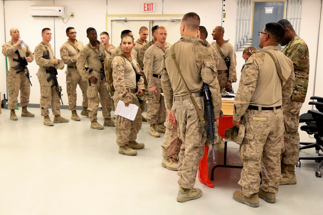 U.S. Navy Petty Officer 2nd Class Kowalsky Lucien informs U.S. Marines ...