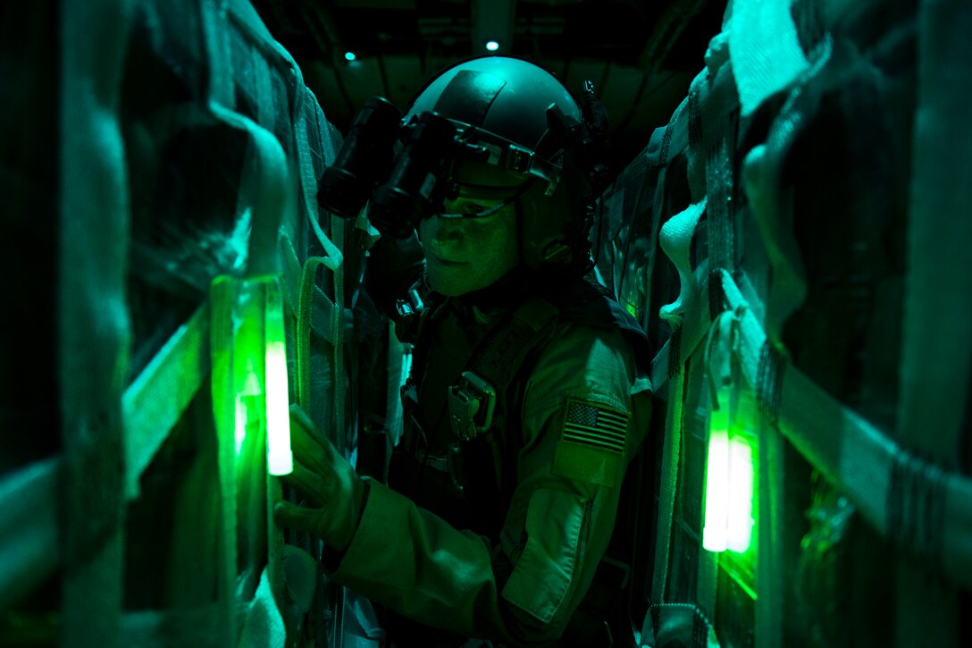 U.S. Air Force Master Sgt. Pennie J. Brawley counts halal meals inside a C-130 Hercules during a humanitarian airdrop over Iraq, Aug. 14, 2014. The humanitarian aid included bottled water and food for displaced citizens of Sinjar, Iraq. Brawley is a loadmaster assigned to the 746th Expeditionary Airlift Squadron.