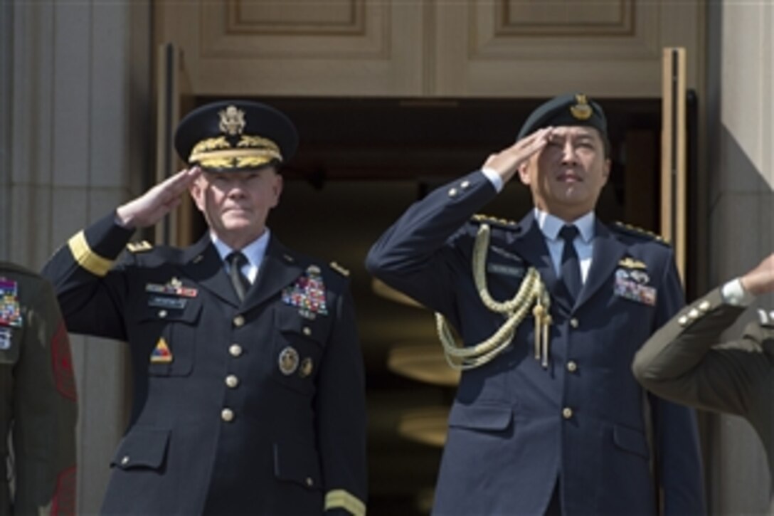U.S. Army Gen. Martin E. Dempsey, chairman of the Joint Chiefs of Staff, and Singaporean Chief of Defense Force Lt. Gen. Ng Chee Meng salute during an honor cordon on the steps of the Pentagon, Aug. 21, 2014. The two leaders met to discuss issues of mutual importance.