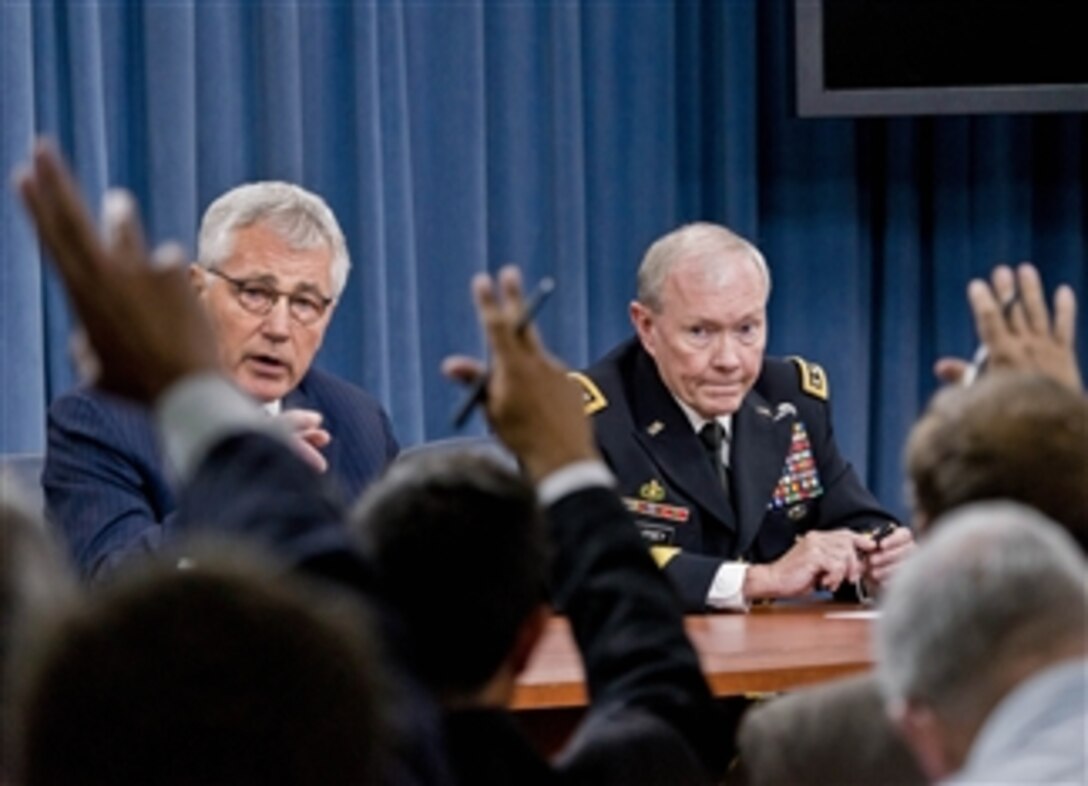 Defense Secretary Chuck Hagel and Army Gen. Martin E. Dempsey, chairman of the Joint Chiefs of Staff, brief reporters at the Pentagon, Aug. 21, 2014.