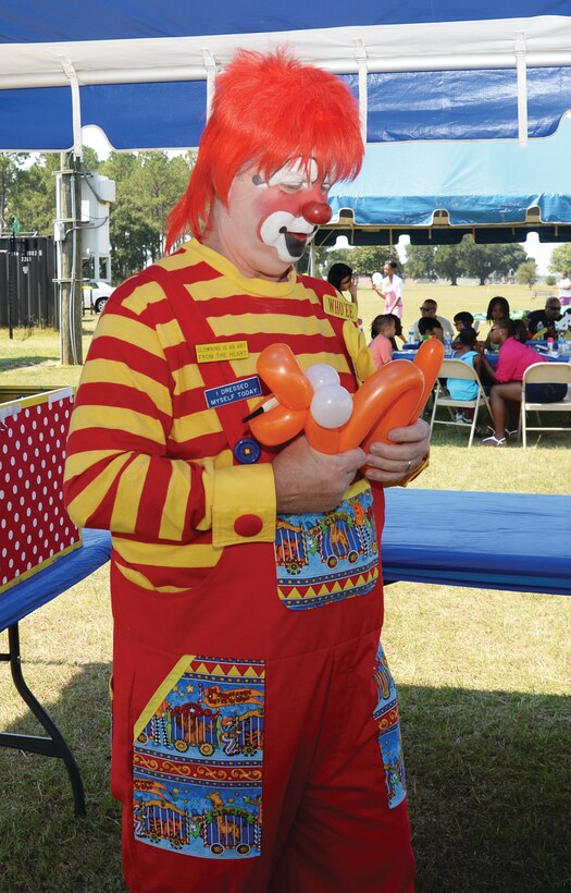 Who’ee the Clown creates balloon characters for children attending a carnival at Marine Corps Logistics Base Albany’s Boyett Park, Aug. 16. 