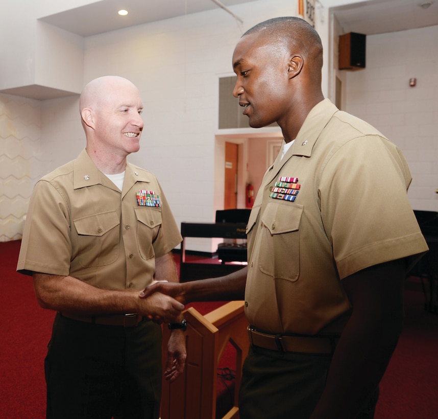 Marine Corps Logistics Base Albany's retiring executive officer, Lt. Col. Daniel L. Bates, (left) shakes hands with the installation's new executive officer, Lt. Col. Nathaniel K. Robinson at Bates' retirement ceremony, Friday, at the Chapel of the Good Shepherd at MCLB Albany.