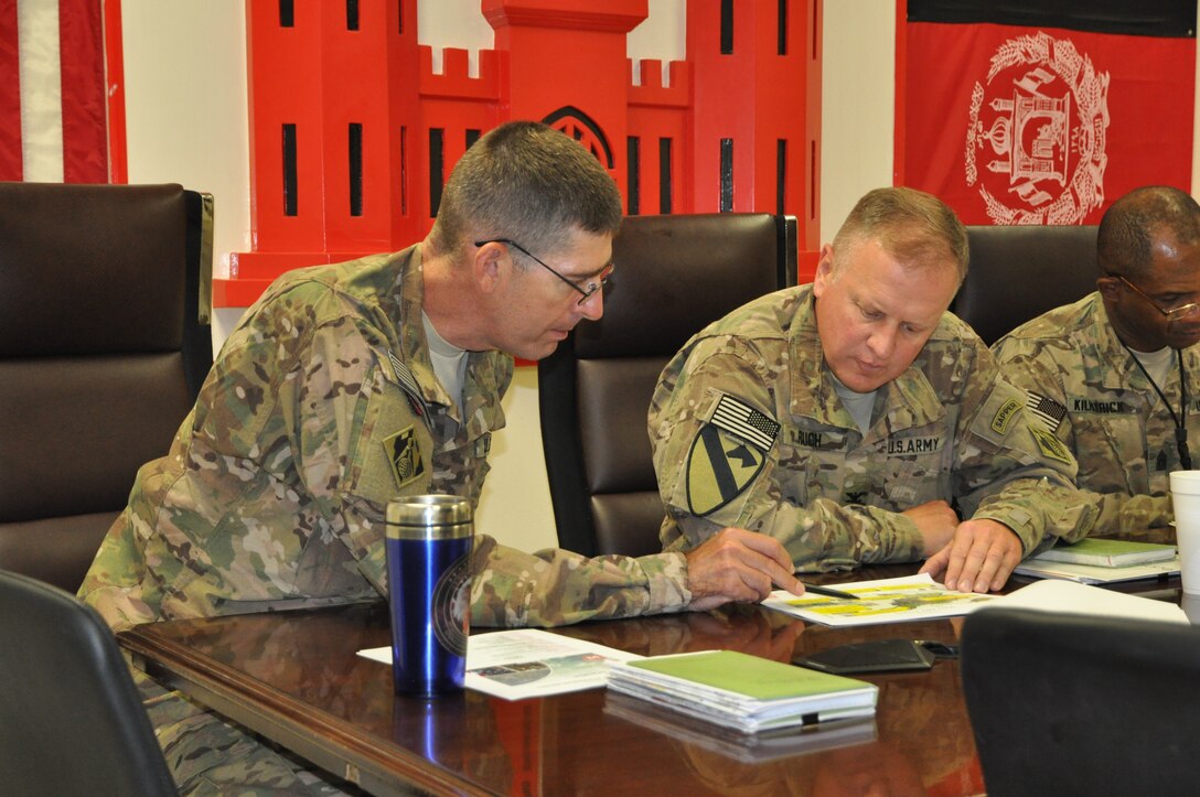 Transatlantic Afghanistan District commander Col. Pete Helmlinger (left), and Huntsville Center commander Col. Bob Ruch review details during a command briefing Ruch received during his recent visit to the district. Ruch also visited with Huntsville Center personnel deployed in support of operations in theater.