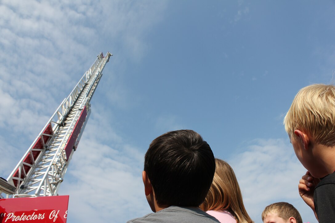 A group of children attending Vacation Bible School aboard Marine Corps Base Quantico gaze at the top of a Quantico fire truck ladder Aug. 5, during Vacation Bible School. 