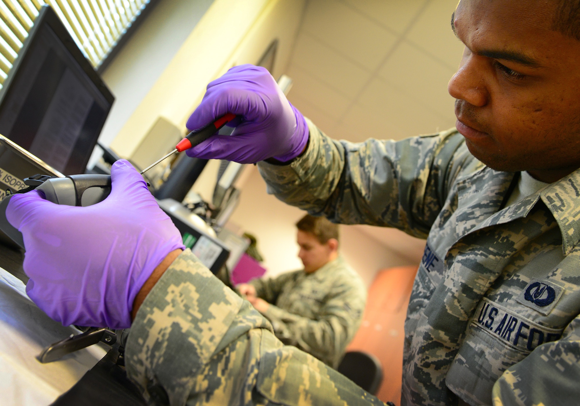 Airman 1st Class Jonathan Greene repairs a pilot’s lip light on an MBU 20-P mask, Aug. 19, 2014, at Aviano Air Base, Italy. The lip light turns on when a pilot presses it with his tongue inside the mask, allowing the pilot to light-up the cockpit and see dark areas during night operations. Greene is a 31st Operations Support Squadron aircrew flight equipment technician. (U.S. Air Force photo/Senior Airman Matthew Lotz)