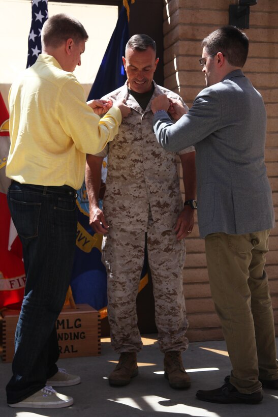 Major Gen. Vincent A. Coglianese (center), commanding general, 1st Marine Logistics Group, gets pinned on by his sons, Anthony Coglianese (left) and Vincent Coglianese (right), during his promotion to major general aboard Camp Pendleton, Calif., Aug. 19, 2014.