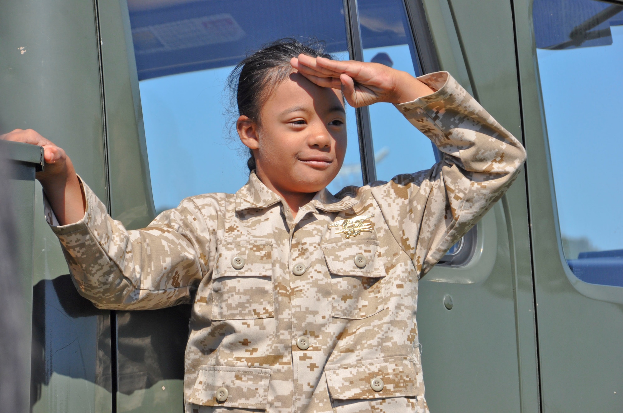 D’Marrion Otten, a Make-a-Wish foundation wish recipient, salutes to show appreciation for the people that worked together to make his wish of becoming a superhero for a day come true Aug 15,2014, at Solano Community College in Fairfield, Calif. Make-a-Wish partnered with Travis Air Force Base, the Coast Guard and the Solano County Sheriff's Department.   (U.S. Air Force photo/Airman 1st Class Amber Carter)