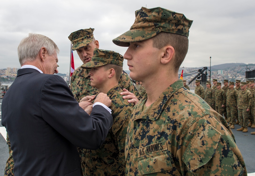 Secretary of the Navy Ray Mabus promotes Lance Cpl. Zachary Yerian and Lance Cpl. Marshall Hardin, 1st Battalion, 23rd Marines, on his visit to the LSDH Sargento Aldea in support of Partnership of the Americas 2014. POA 14 is designed to enhance joint and combined interoperability, increase the combined capability to execute Amphibious Operations, Peace Support Operations, and Humanitarian Assistance/Disaster Relief missions, and further develop strong and lasting relationships the U.S. Marine Corps has established with partner nations' naval infantries/marine corps.


