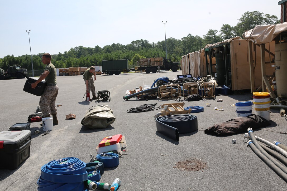 Pfc. Benjamin Alvarez, left, and Lance Cpl. Wesley Pricer inventory a tactical water purification system at Marine Corps Air Station Cherry Point, N.C., Aug. 19, 2014, after returning from a two-week field exercise. Alvarez and Pricer are both water purification specialists with Marine Wing Support Squadron-271.