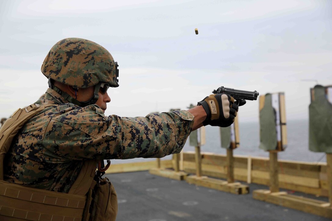 Petty Officer 3rd Class James Johnson, a U.S. Navy hospital corpsman with Special Purpose Marine Air Ground Task Force South, and a native of New Orleans, fires at his target during a live-fire exercise on the flight deck of the future amphibious assault ship USS America (LHA 6), Aug. 15, 2014. The purpose of the exercise was to refresh the Marines on weapons handling and marksmanship with the M4 service rifle and M9 service pistol. Training like this ensures that Marines with the SPMAGTF are prepared to provide our nation and partners with the capacity to respond immediately to a multitude of crisis. SPMAGTF-South is currently embarked aboard America on her maiden transit dubbed, “America Visits the Americas.”  (U.S. Marine Corps photo by Cpl. Christopher J. Moore/Released)