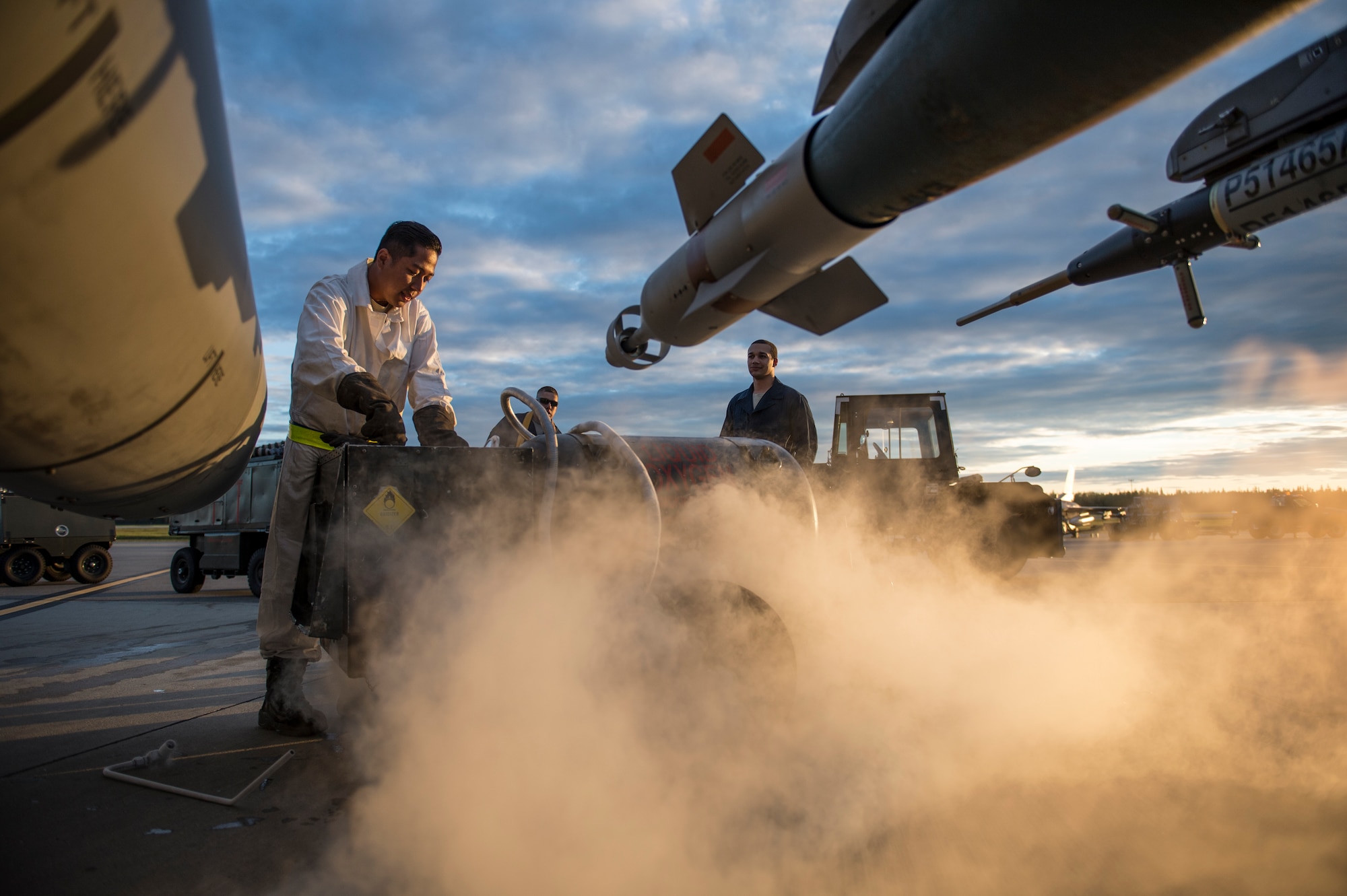 Senior Airman Adam Nop purges a liquid oxygen cart during Red Flag-Alaska 14-3 Aug. 19, 2014, on Eielson Air Force Base, Alaska. At high altitudes, pilots must breathe with oxygen-supplemented breathing systems to compensate for the decreased air pressure. Nop is a 80th Aircraft Maintenance Squadron crew chief assigned to Kunsan Air Base, South Korea. (U.S. Air Force photo/Senior Airman Peter Reft)