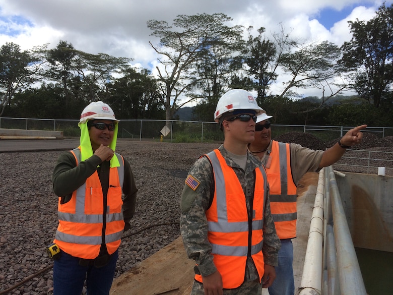 SCHOFIELD BARRACKS, Hawaii (July 29, 2014) --Cadet Kyle Underwood (center), Honolulu District Construction Control Representative Daniel Wong (left), and Project Engineer Randy Itamoto discuss features of the Central Vehicle Wash Facility Project on Schofield Barracks. Underwood is a West Point Cadet. He came to the Honolulu District this summer for the Cadet District Engineer Program. This program allows West Point and ROTC Cadets an opportunity to gain first-hand experience with construction and engineering in the U.S. Army Corps of Engineers. Cadets are typically assigned for one month of training at Corps Districts to assist work on military construction, civil, mechanical, electrical, or environmental engineering projects. The program provides them exposure to the Corps’ mission and enables them to explore potential active duty opportunities within the U.S. Army Engineer Branch profession.