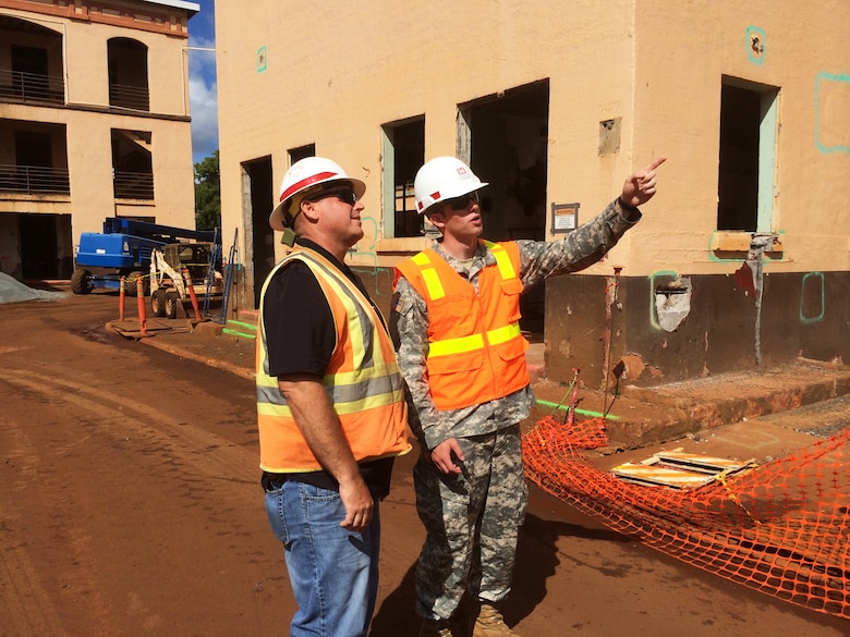 SCHOFIELD BARRACKS, Hawaii (July 29, 2014) --Cadet Matt S. Borland (right) and Honolulu District Construction Control Representative Joseph Tribbey discuss the features of the Quad B Renovation Project on Schofield Barracks. Borland is an ROTC Cadet with the University of Michigan.  He came to the Honolulu District this summer for the Cadet District Engineer Program. This program allows West Point and ROTC Cadets an opportunity to gain first-hand experience with construction and engineering in the U.S. Army Corps of Engineers. Cadets are typically assigned for one month of training at Corps Districts to assist work on military construction, civil, mechanical, electrical, or environmental engineering projects. The program provides them exposure to the Corps’ mission and enables them to explore potential active duty opportunities within the U.S. Army Engineer Branch profession.