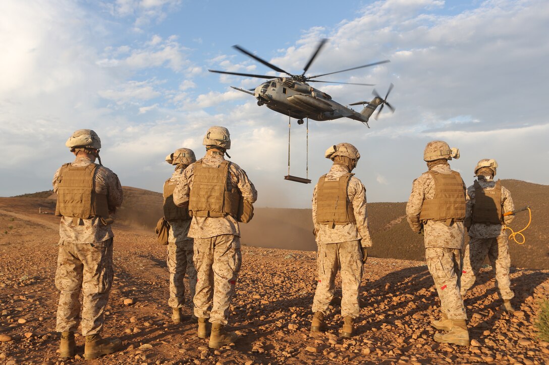 A Helicopter Support Team with Combat Logistics Regiment 17 waits for a CH-53E Super Stallion with Marine Heavy Helicopter Squadron (HMH) 462 to drop off simulated cargo during HST training aboard Marine Corps Air Station Miramar, Calif., Aug. 21. The team attached the cargo 15 times, moving a total of 120,000 pounds during the exercise.