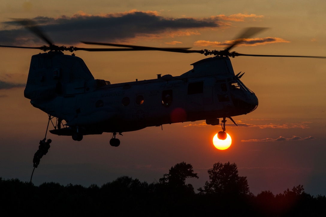 A U.S. Marine assigned to Echo Company 4th Reconnaissance Battalion fast ropes out of a CH-46E Sea Knight helicopter at Camp Upshur, Marine Corps Base Quantico Virginia, July 17, 2014.  The training exercise was part of a week-long jump, dive, breach, and shooting package conducted around MCB Quantico. 