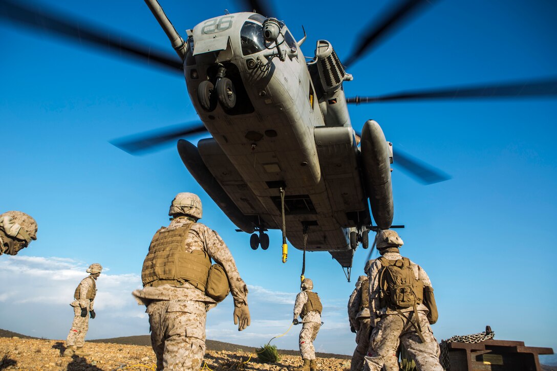 A CH-53E Super Stallion with Marine Heavy Helicopter Squadron (HMH) 462 maintains an extremely low altitude for a Helicopter Support Team with Combat Logistics Regiment 17 aboard Marine Corps Air Station Miramar, Calif., Aug. 21. HMH-462 transported simulated cargo while the HST conducted training that included connecting and disconnecting cargo. (U.S. Marine Corps photo by Cpl. Owen Kimbrel)