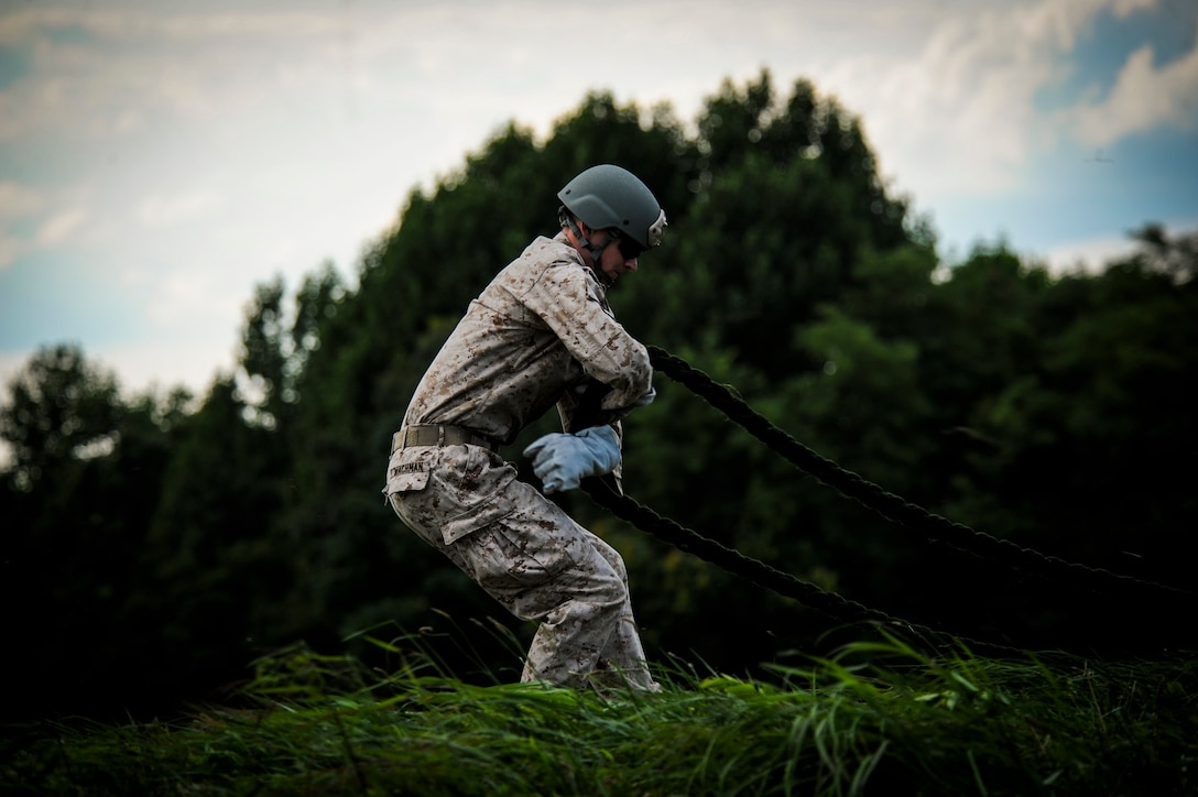 A Marine assigned to Echo Company 4th Reconnaissance Battalion prepares to rappel out of a CH-46E Sea Knight helicopter at Camp Upshur, Marine Corps Base Quantico, July 17, 2014. The training exercise was part of a weeklong jump, dive, breach and shooting package conducted around MCB Quantico.
