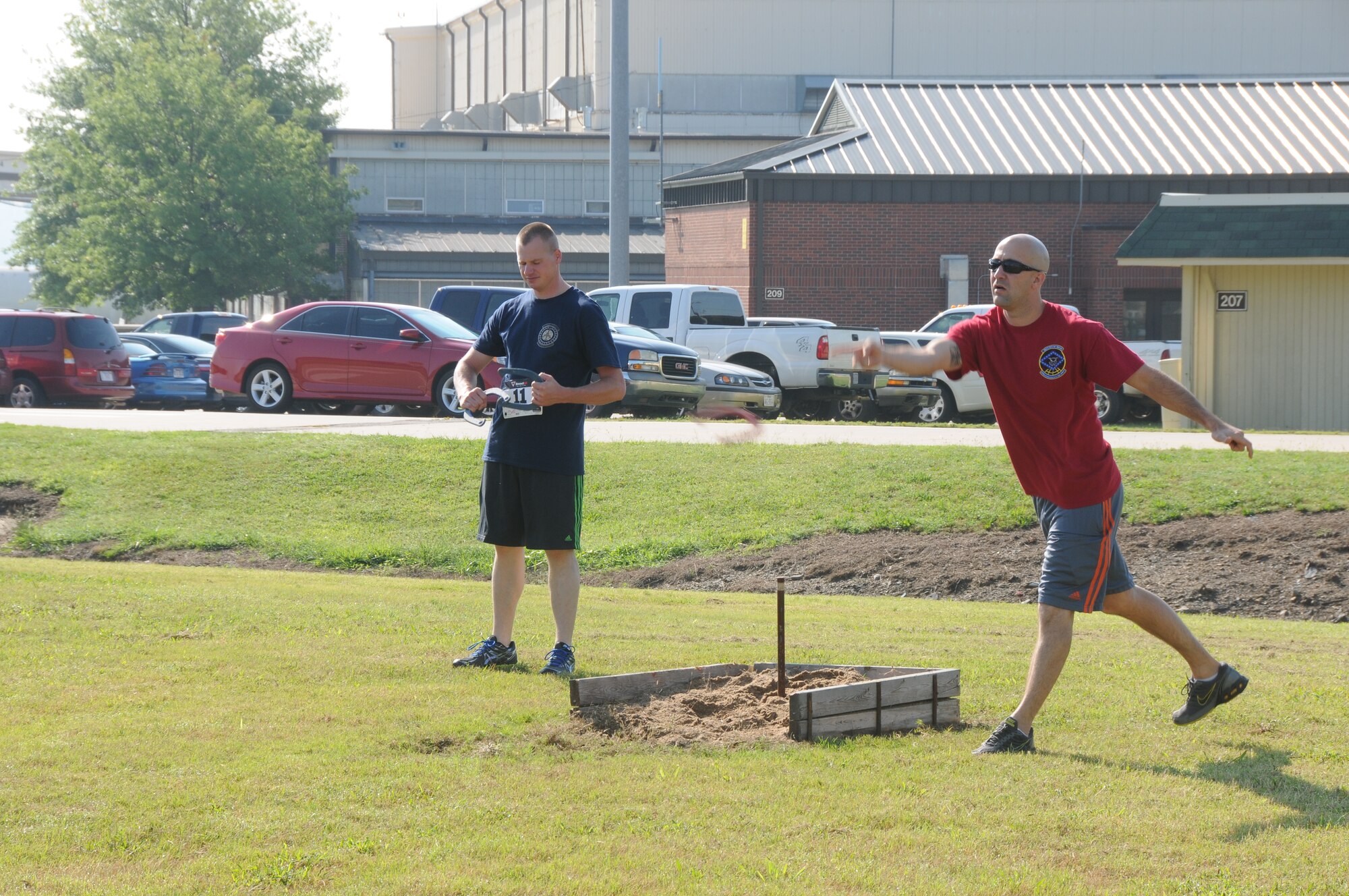 Tech Sgt. Keelan Hunt, 153rd Intelligence Squadron, participates in a game of horseshoes during Wingman Day at the 188th Wing’s Ebbing Air National Guard Base Fort Smith, Arkansas, on Aug. 2, 2014. Events included volleyball, a free throw contest, a 1.5-mile run, fishing pole casting contest, golf chipping contest, golf cart driving course, and multiple fitness stations competition. (U.S. Air National Guard photo by Airman 1st Class Cody Martin/released)