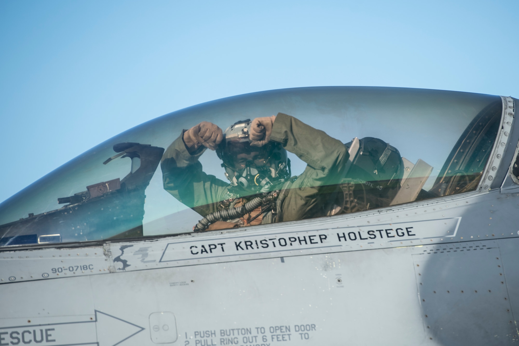 U.S. Air Force Capt. Chirstopher Franks, 80th Fighter Squadron F-16 Fighting Falcon pilot assigned to Kunsan Air Base, South Korea, strikes a Wolf Pack "Crush Um" pose during RED FLAG-Alaska 14-3 Aug. 22, 2014, Eielson Air Force Base, Alaska. Franks participated in large-scale combat simulations with air combat units from the U.S. Navy, Marine Corps and Air National guard. (U.S. Air Force photo by Senior Airman Peter Reft/Released)