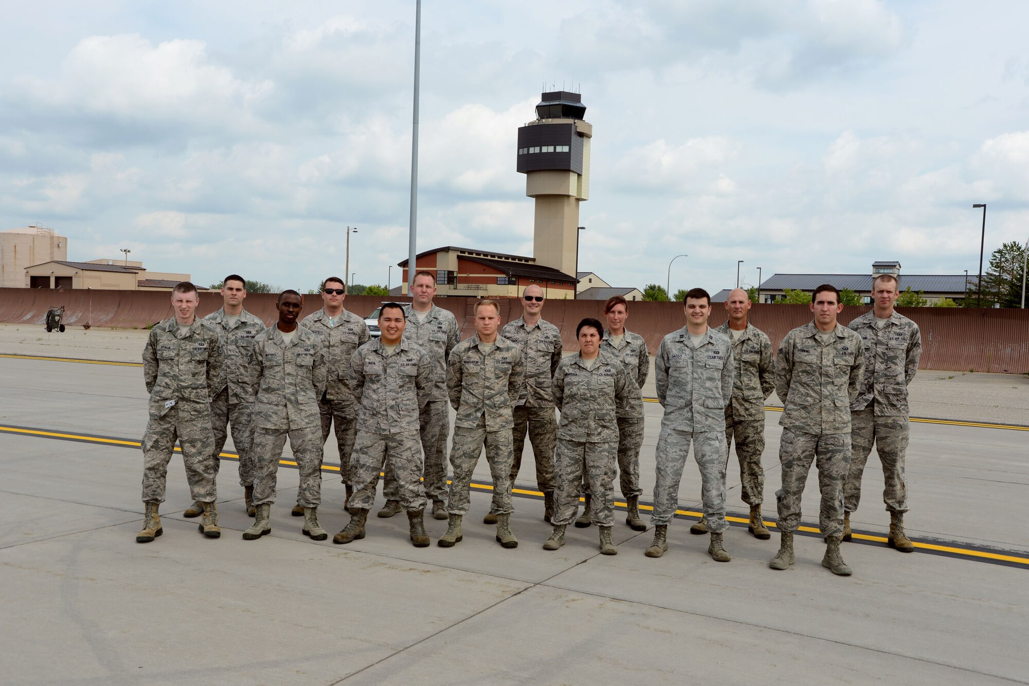 With the air traffic control tower in the background, members from the 319th Operations Support Squadron pose for a group photo on the flightline of Grand Forks Air Force Base, N.D., on Aug. 20, 2014. The active-duty Airmen from the 319th Air Base Wing directly supported the first ever Unmanned Aircraft Systems Airspace Integration Test in the U.S., which took place Aug. 4-22, 2014, at Grand Forks AFB. (U.S. Air Force photo/Senior Master Sgt. David Lipp)