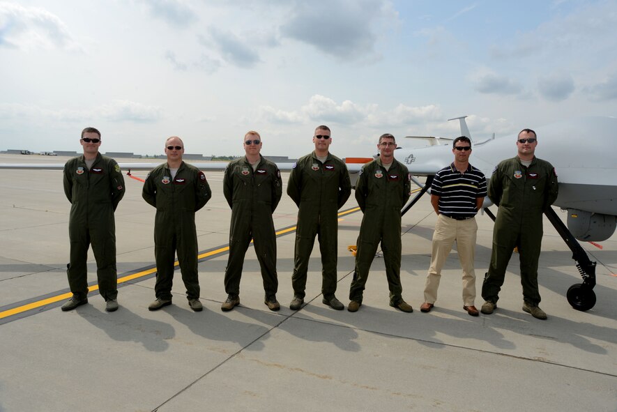 Members from the North Dakota Air National Guard’s 119th Wing, Detachment 1 pose for a group photo in front of an MQ-1 Predator on the flightline of Grand Forks Air Force Base, N.D., on Aug. 20, 2014. The Happy Hooligans from Fargo, N.D., along with local active-duty Airmen from Grand Forks AFB operated the unmanned aerial vehicles such as Predator and RQ-4 Global Hawks (Block 40) during the first ever Unmanned Aircraft Systems Airspace Integration Test in the U.S. Aug. 4-22, 2014, at Grand Forks AFB. (U.S. Air Force photo/Senior Master Sgt. David Lipp)