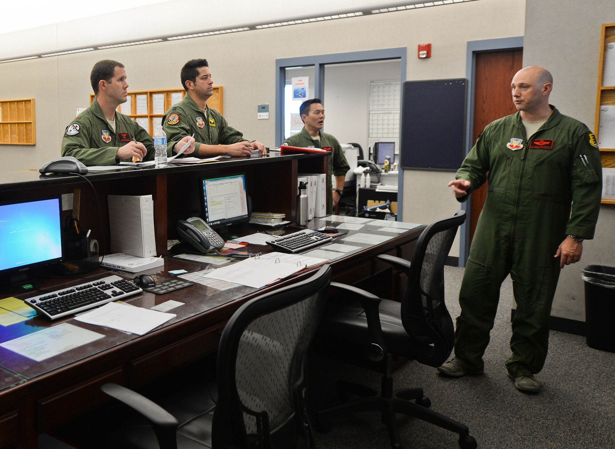 Lt. Col. Ryan Carignan, 34th Bomb Squadron project officer, briefs B-1 bomber aviators from the 34th BS in preparation for the stand-off weapons integration exercise at Ellsworth Air Force Base, S.D., Aug. 13, 2014. The purpose of the exercise was to train B-1 aircrews and B-52 Stratofortress aircrews assigned to the 23rd Bomb Squadron, Minot Air Force Base, in the employment of stand-off weapons during simulated tactical scenarios to prepare for real world contingencies. (U.S. Air Force photo by Senior Airman Zachary Hada/Released)