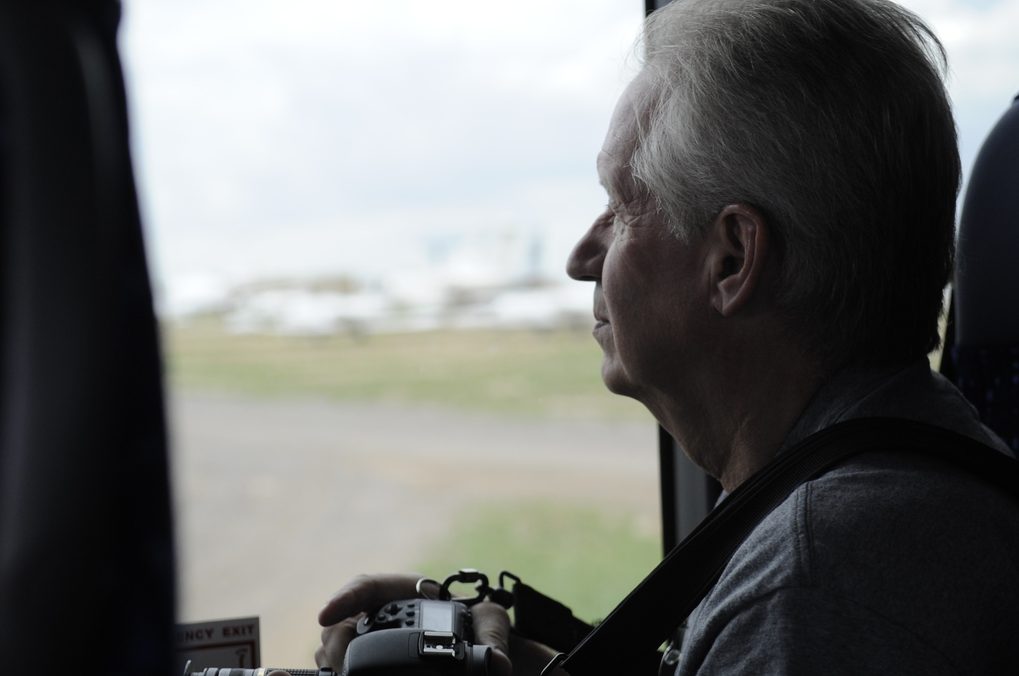 Steve Pope, a Phoenix resident, observes aircraft through a bus window during a Pima Air and Space Museum tour of the 309th Aerospace Maintenance and Regeneration Group, on Davis-Monthan Air Force Base, Ariz., Aug. 21, 2014.  The PASM set a new July record for visitors after 2,060 people toured AMARG, breaking the old July record of 1,740 visitors in 2008. (U.S. Air Force photo by Airman 1st Class Betty R. Chevalier/Released)