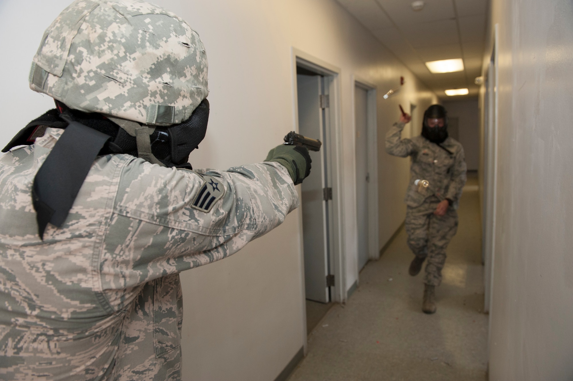 Senior Airman Juan Salinas, 460th Security Forces Squadron, responds to a threat during a shoot no-shoot challenge, during the 460th Operations Group Panther Challenge, designed to teach security forces members when and how to respond to a threat Aug 11, 2014, on Buckley Air Force Base, Colo. The challenge, held Aug. 4-13, was developed to provide members of Team Buckley an opportunity to improve their skills and expand their job knowledge in a competitive setting. Participants in the challenge included the 2nd and 8th Space Warning Squadrons, 460th Security Forces Squadron, and 460th Medical Group. (U.S. Air Force photo by Senior Airman Phillip Houk/Released)