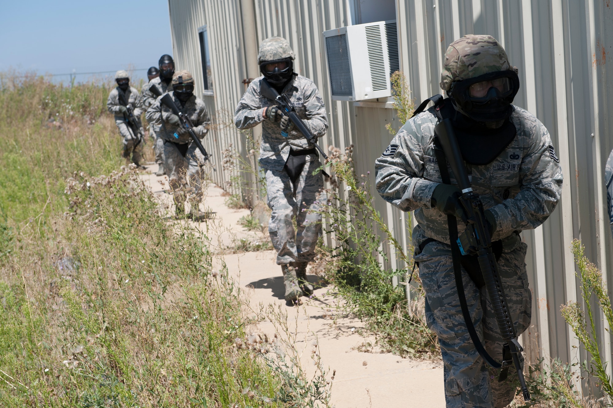 Members of the 460th Operations Group act as opposing forces during a field training exercise as part of the Panther Challenge, designed to allow space operators and 460th Security Forces Squadron members experience in what to do during a crisis situation Aug 11, 2014, on Buckley Air Force Base, Colo. The challenge, held Aug. 4-13, was developed to provide members of Team Buckley an opportunity to improve their skills and expand their job knowledge in a competitive setting. Participants in the challenge included the 2nd and 8th Space Warning Squadrons, 460th Security Forces Squadron, and 460th Medical Group. (U.S. Air Force photo by Senior Airman Phillip Houk/Released)