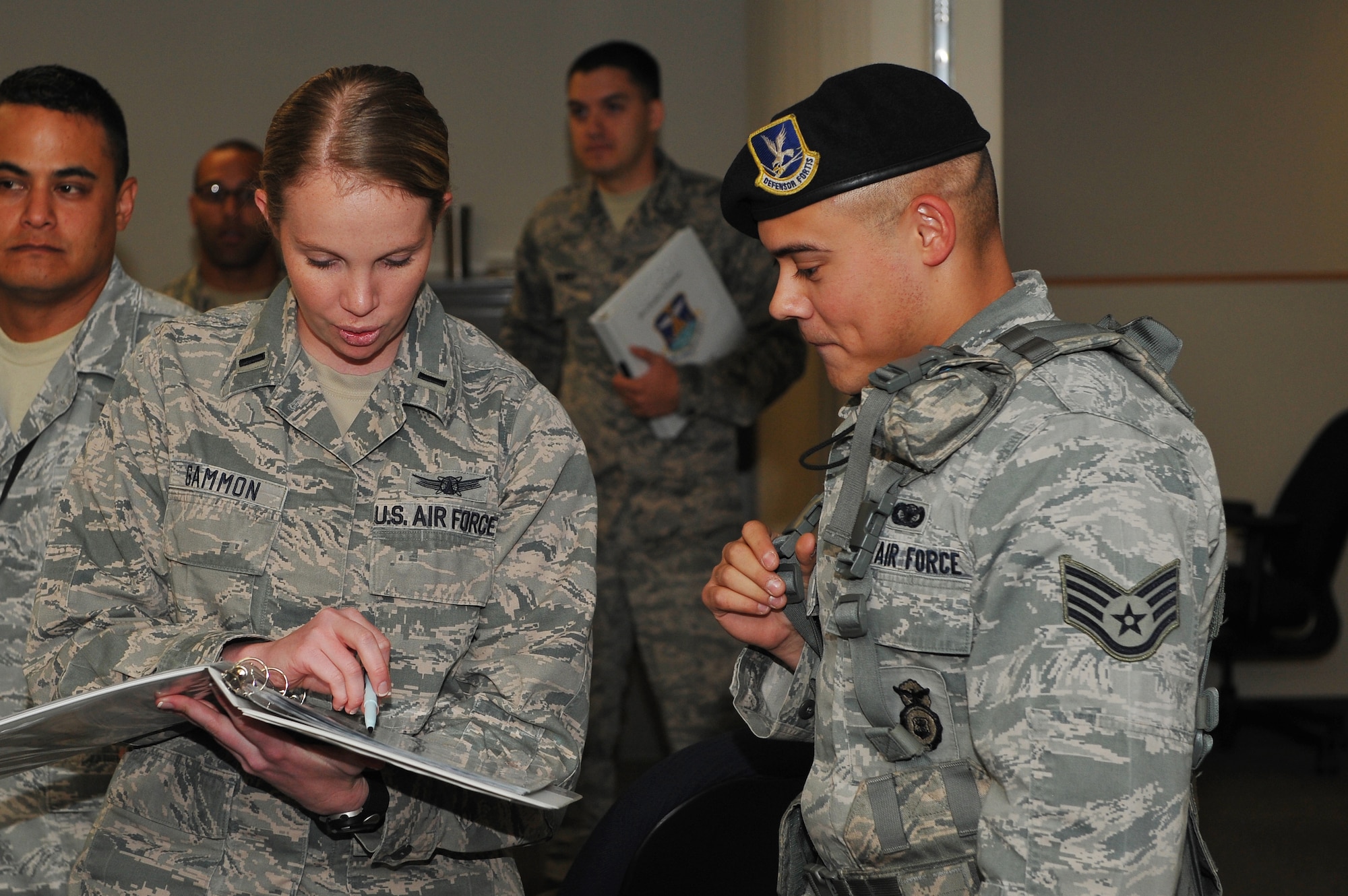 1st Lt. Ashley Gammon, 2nd Space Warning Squadron, left, reviews the building evacuation plan with Staff Sgt. Vincent Rios, 460th Security Forces Squadron, after a simulated bomb scenario during the Panther Challenge Aug. 11, 2014,on Buckley Air Force Base, Colo. The challenge, held Aug. 4-13, was developed to provide members of Team Buckley an opportunity to improve their skills and expand their job knowledge in a competitive setting. Participants in the challenge included the 2nd and 8th Space Warning Squadrons, 460th Security Forces Squadron, and 460th Medical Group. (U.S. Air Force photo by Senior Airman Phillip Houk/Released)