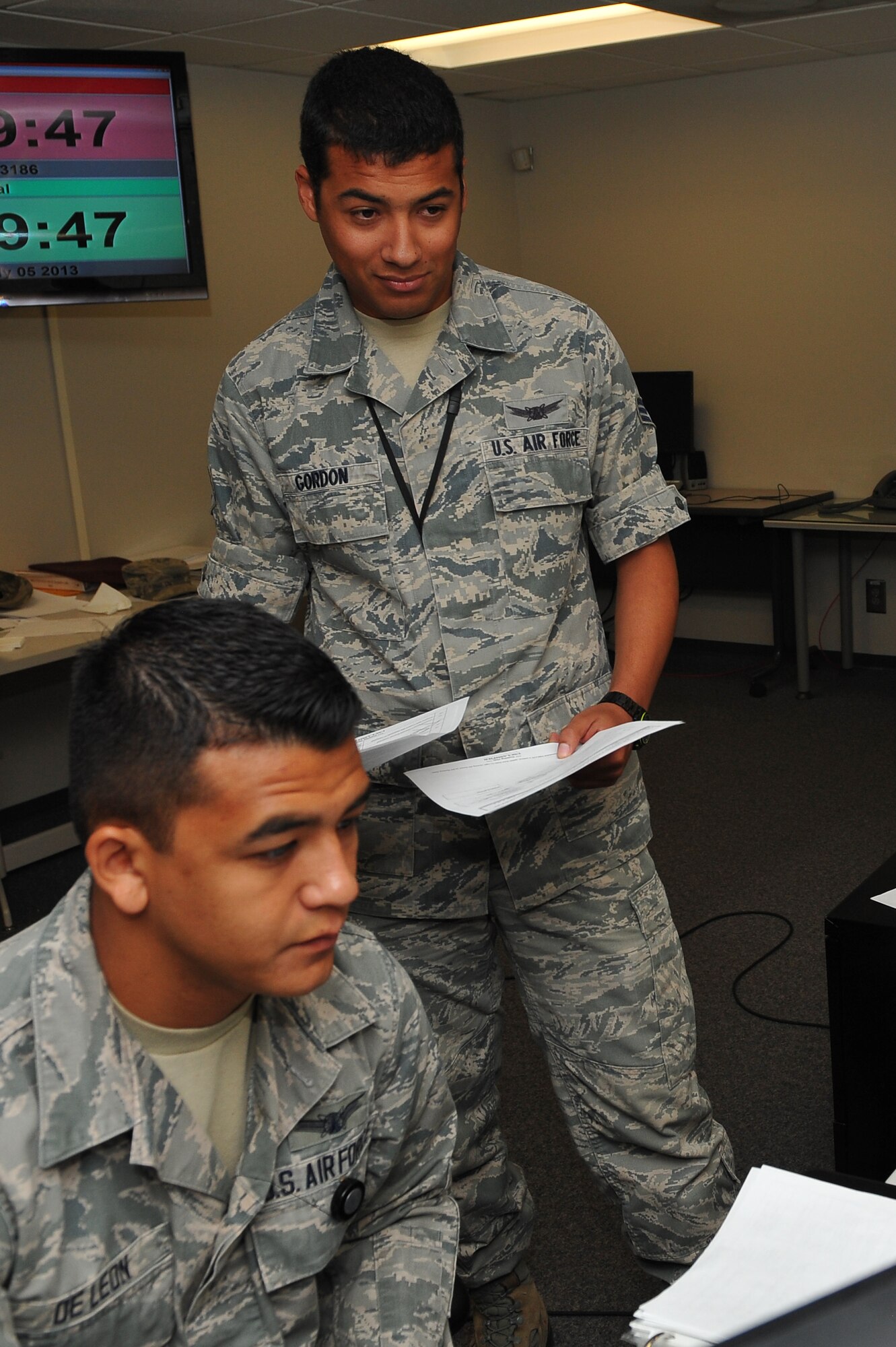 Senior Airman Nelson Gordon, 140th Operations Support Squadron, right, works with Airman 1st Class Christian De Leon, 2nd Space Warning Squadron, to complete an objective during the 460th OG Panther Challenge Aug. 11, 2014, on Buckley Air Force Base, Colo. The challenge, held Aug. 4-13, was developed to provide members of Team Buckley an opportunity to improve their skills and expand their job knowledge in a competitive setting. Participants in the challenge included the 2nd and 8th Space Warning Squadrons, 460th Security Forces Squadron, and 460th Medical Group. (U.S. Air Force photo by Senior Airman Phillip Houk/Released)