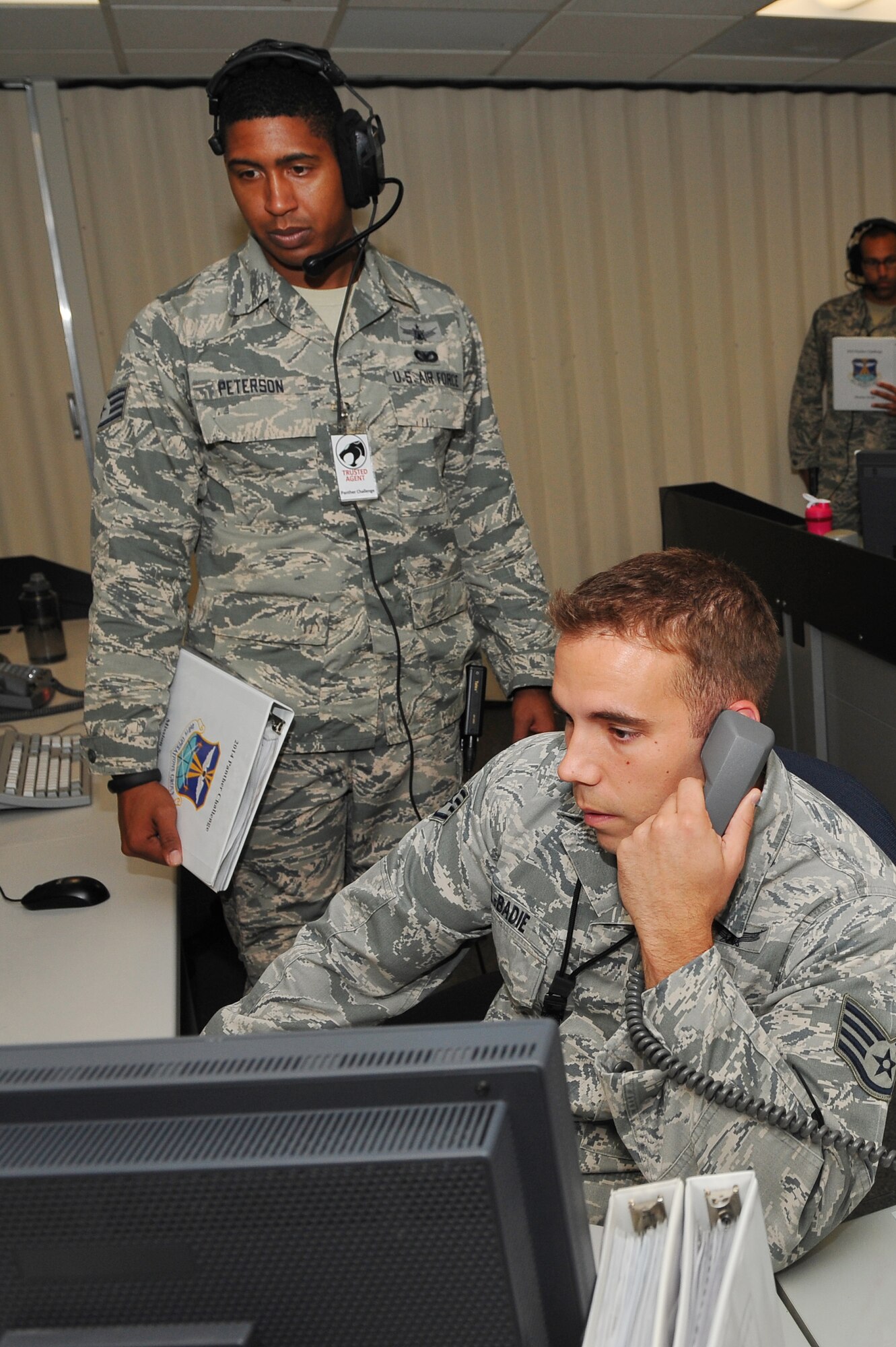 Staff Sgt. Glenn Labadie, 2nd Space Warning Squadron space operator, right, is evaluated by Staff Sgt. Harrel Peterson, 460th Operations Group, during the 460th Operations Group Panther Challenge Aug. 11, 2014, on Buckley Air Force Base, Colo. The challenge, held Aug. 4-13, was developed to provide members of Team Buckley an opportunity to improve their skills and expand their job knowledge in a competitive setting. Participants in the challenge included the 2nd and 8th Space Warning Squadrons, 460th Security Forces Squadron, and 460th Medical Group. (U.S. Air Force photo by Senior Airman Phillip Houk/Released)