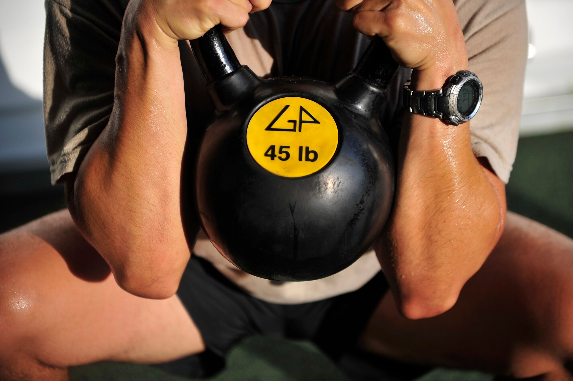 An Airman performs a goblet squat during a functional fitness class at the Aderholt Fitness Center, Hurlburt Field, Fla., Aug. 22, 2014. Fitness instructors taught Airmen to use functional movements to maximize their strength. (U.S. Air Force photo/Staff Sgt. Tyler Placie)