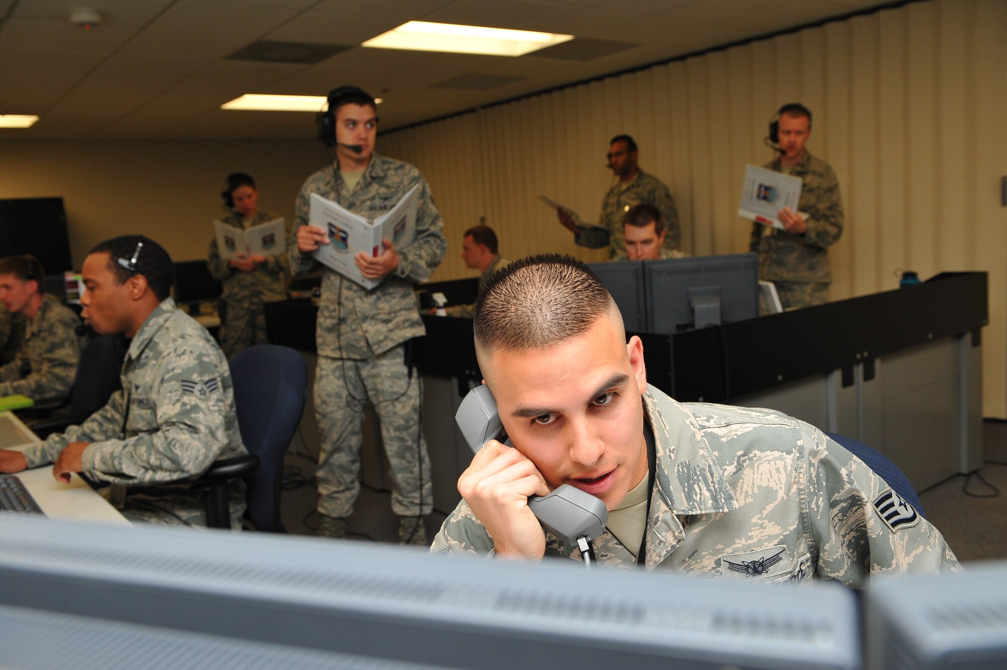 Staff Sgt. Michael Gonzales, 2nd Space Warning Squadron, works with his crew to address all scenarios presented to him during the 460th Operations Group Panther Challenge Aug. 7, 2014, on Buckley Air Force Base, Colo. The challenge, held Aug. 4-13, was developed to provide members of Team Buckley an opportunity to improve their skills and expand their job knowledge in a competitive setting. Participants in the challenge included the 2nd and 8th Space Warning Squadrons, 460th Security Forces Squadron, and 460th Medical Group. (U.S. Air Force photo by Senior Airman Phillip Houk/Released)