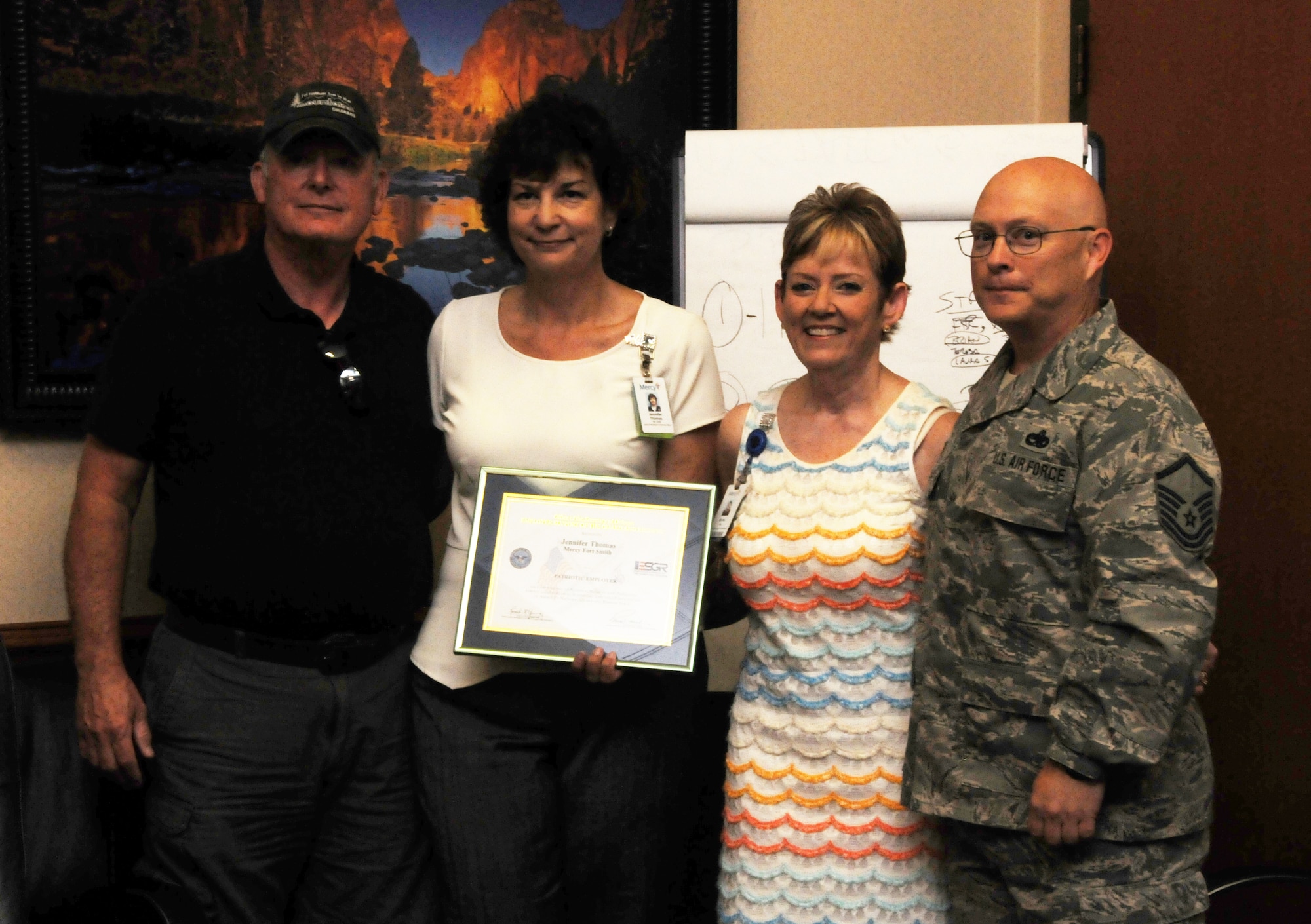 From left: Bobby Thomas, Jennifer Thomas, Shirley Bearden and Master Sgt. Mike Bearden. Thomas employs Shirley Bearden, who is also a key volunteer with the 188th Airman and Family Readiness Office. The Beardens honored Jennifer Thomas, vice president of ancillary services at Mercy Fort Smith, Arkansas, with an ESGR Patriot Award for her exceptional support during Master Sgt. Bearden’s 2012 deployment to Afghanistan. (U.S. Air National Guard photo by Maj. Heath Allen/released)